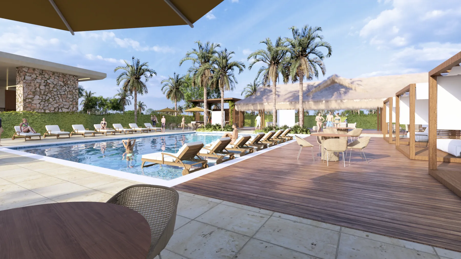 Piscina del club con asoleadoras, deck de madera y kioscos de palma
